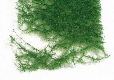 23 - Gros plan sur la texture du tapis «prairie» : fibres entrelacées et flocage fin.
